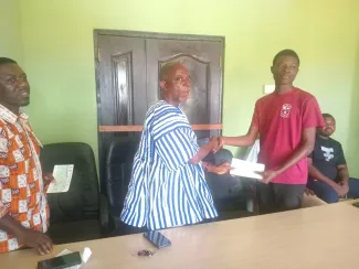 A beneficiary receiving his cheque